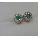 PAIR OF 18CT GOLD EMERALD & DIAMOND CLUSTER EAR STUDS Condition Report: Emeralds are