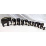 HERD OF CARVED WOODEN BLACK ELEPHANTS