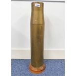 ARTILLERY SHELL STICK STAND ON A TURNED WOODEN BASE,