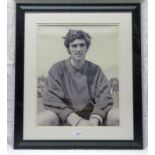 SIGNED PHOTOGRAPH OF A YOUNG GEORGE BEST IN A TRAINING TOP - 49 X 39 CMS