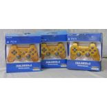 THREE SONY DUALSHOCK 3 GOLD CONTROLLERS.