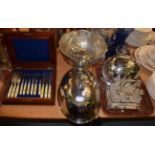 A graduated set of three meat domes, a plated punch bowl and cups, a plated cruet set and a