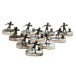 A set of twelve Italian silver place-card holders, each on oval base, applied with a cast putto