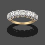 A Diamond Seven Stone Ring, the round brilliant cut diamonds in broad white claw settings, to a