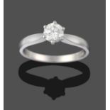 A Platinum Diamond Solitaire Ring, a round brilliant cut diamond in a claw setting, to knife edge