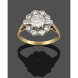 A Diamond Cluster Ring, a central round brilliant cut diamond within a border of smaller round