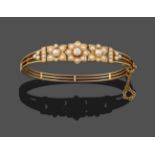 A Cultured Pearl and Diamond Bangle, three graduated cultured and split pearl set floral motifs
