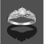 A Platinum Diamond Solitaire Ring, a round brilliant cut diamond in a claw setting, to tapered