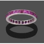 A Ruby Eternity Ring, the step cut rubies in a white flat sided shank, finger size L1/2 see