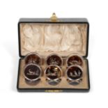 A Cased Set of Six George V Silver-Mounted Tortoiseshell Place-Card Holders, by William Comyns,