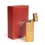 A Gold and Gold-Plate Mounted Cigarette-Lighter, Retailed by Cartier, 20th Century, Model Number