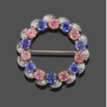 A Tanzanite, Pink Sapphire and Diamond Circular Brooch, seven round cut tanzanites in white claw