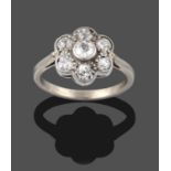 A Diamond Cluster Ring, seven old cut diamonds in white millegrain settings, to a tapered shoulder
