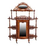 A Victorian Burr Walnut Whatnot, circa 1870, of graduated form with an oval moulded frame above a