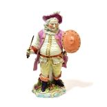 ^ A Derby Porcelain Figure of Falstaff, circa 1775, standing holding a sword in one hand, his shield