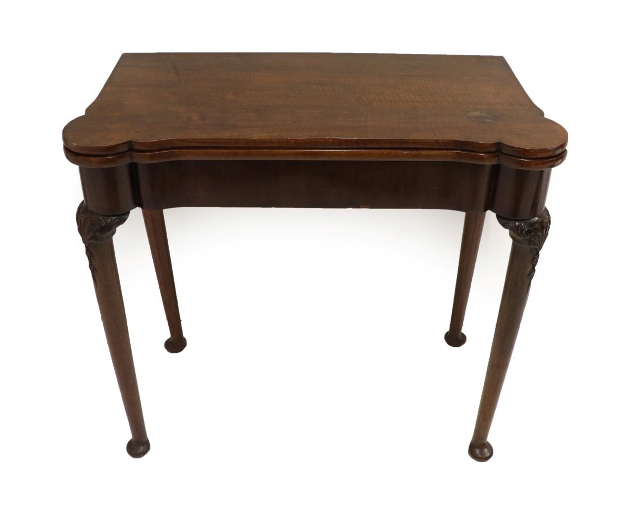 A George II Mahogany Foldover Games Table, mid 18th century, of serpentine shaped form, with folding