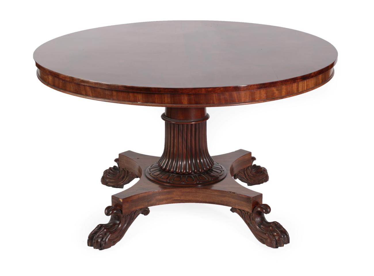 An Early Victorian Mahogany Circular Dining Table, circa 1840, with plain frieze, on a reeded