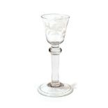 A Wine Glass, circa 1750, the rounded funnel bowl engraved with a bird and foliage over a ball knop,