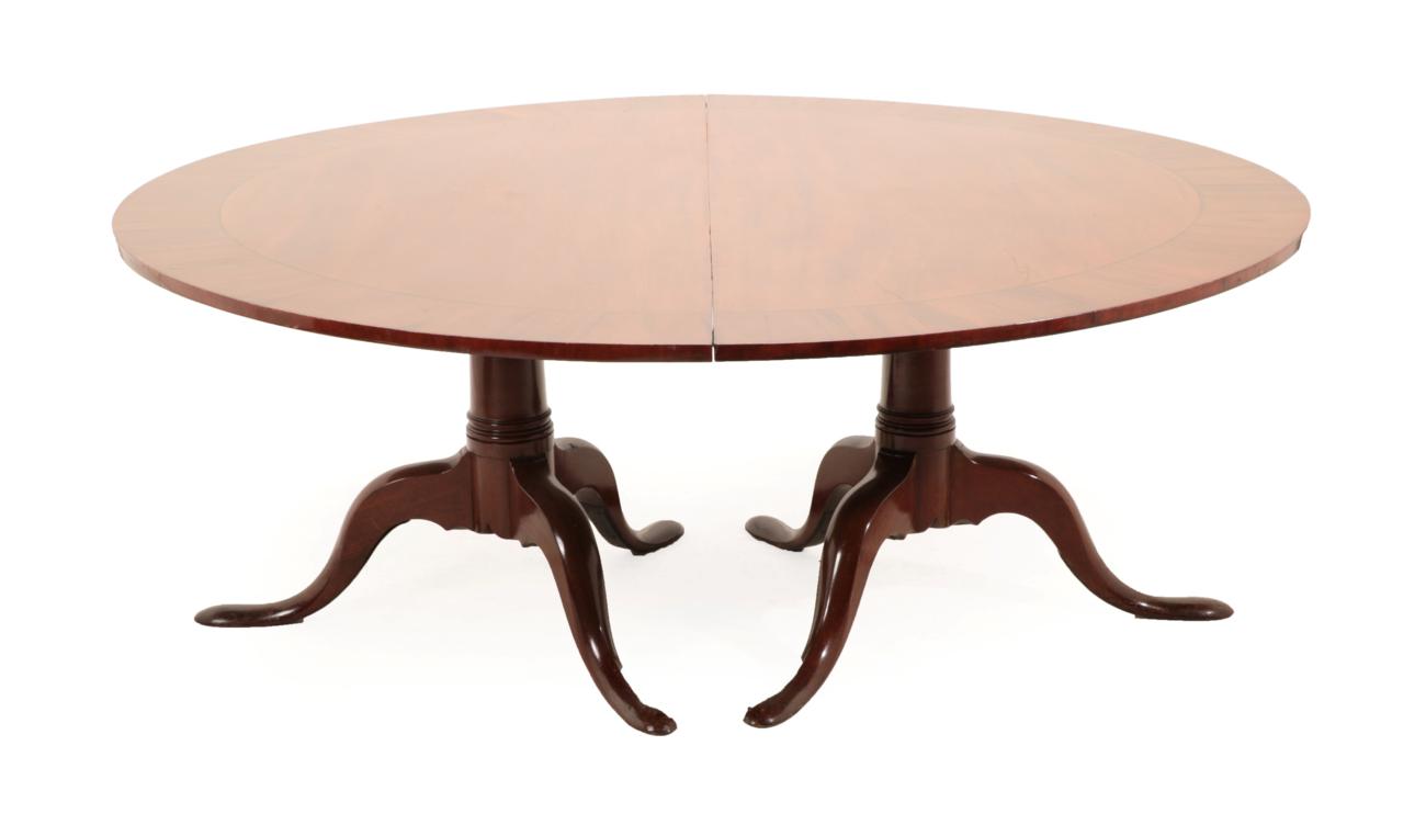 A George III Style Mahogany, Crossbanded and Ebony Strung Twin-Pillar Dining Table, of D shaped form