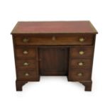 A George III Mahogany Kneehole Desk, circa 1800, with later inset red and gilt leather writing