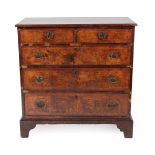 ^ A George I Walnut and Featherbanded Straight Front Chest of Drawers, early 18th century, the