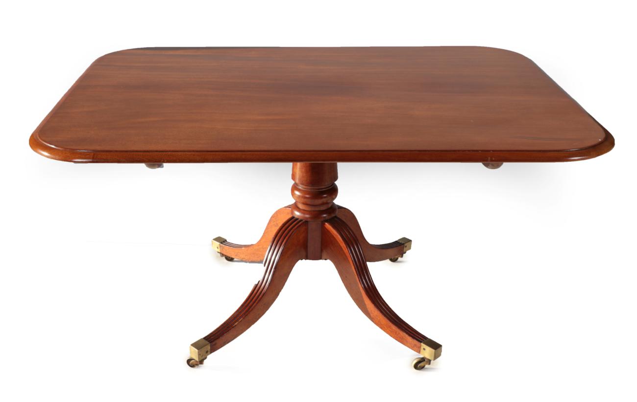 A Late George III Mahogany Tilt-Top Dining Table, early 19th century, of rounded rectangular form,