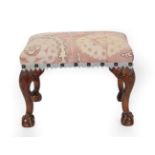 A George II Style Carved Mahogany Stool, early 20th century, recovered in a 19th century plum