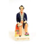 A Staffordshire Pottery Figure of Richard Cobden, mid 19th century, seated, 20cm high