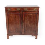 ^ A George III Mahogany Cabinet, early 19th century, the moulded top above two frieze drawers and