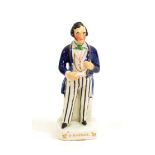 A Staffordshire Pottery Figure of Sir Robert Peel, mid 19th century, in striped trousers, 18cm high