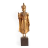 A Thai Gilt Bronze Figure of Buddha, 19th century, standing wearing scroll headdress and bodice, the