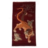 Tibetan Tiger Rug Tibet or Nepal, circa 1950 The tiger in semi-naturalistic form beneath a tree,