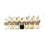 Pharmacy Bottles a collection of 13 clear glass examples with gold bordered labels 6 1/2'' high, 2