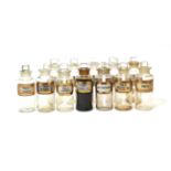 Pharmacy Bottles a collection of 12 clear glass examples with gold bordered labels 6 1/2'' high, 2