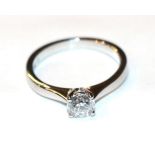 A platinum diamond solitaire ring, a round brilliant cut diamond in a claw setting, to knife edge
