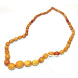 A strand of amber beads, length 76cm . Gross weight 63.6 grams.