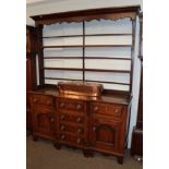 An early 19th century oak break front dresser and rack, 162cm wide