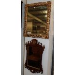 A Victorian carved gilt wood mirror, 61cm high; and a George III style mahogany and fret cut mirror,