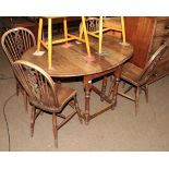 An oak gateleg table, baluster turned legs; together with a set of four wheel back chairs (5)