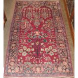 Khoy prayer rug, the raspberry field with an urn and plants beneath the Mihrab, enclosed by indigo