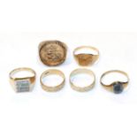 Two 9 carat gold patterned band rings, finger sizes N and Q; a St George coin ring in a 9 carat gold