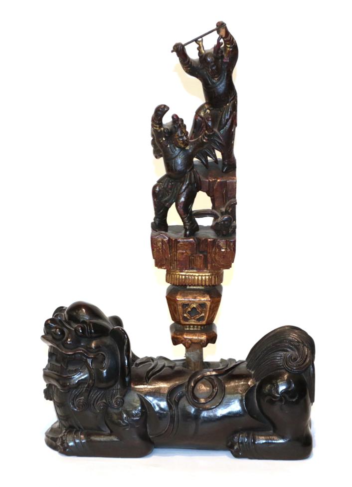 A Chinese carved rootwood dog of Fo, with an associated finial, carved with dancing figures