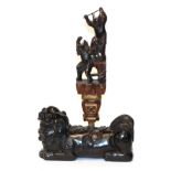 A Chinese carved rootwood dog of Fo, with an associated finial, carved with dancing figures