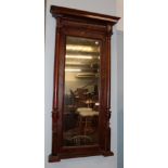 A mahogany bevelled glass pier mirror with tapering turned pilasters