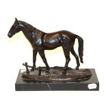 A bronze model of a horse on a black marble plinth