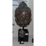 A bronze multiple face Buddha head and a similar smaller head (2)