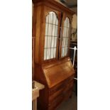 A 1920s oak bureau bookcase with leaded glass doors, 92cm wide