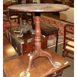 A George III oak tripod table, with turned column, raised on pad feet
