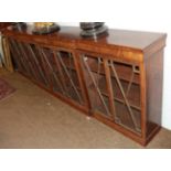 A 19th century mahogany break front low bookcase, the moulded top above four astragal glazed