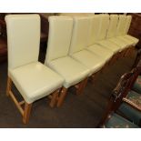 A set of eight modern upholstered oak dining chairs